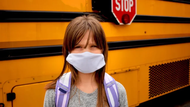 girl-child-covid-mask-school-bus.webp.webp