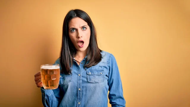 shocked-woman-holding-beer.webp.webp