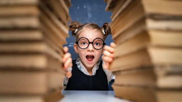 smart-girl-student-with-glasses-stacks-of-books.webp.webp