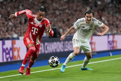 bayern-s-michael-olise-left-and-real-madrid-s-alvaro-carreras-challenge-for-the-ball-during-the-cham.jpeg