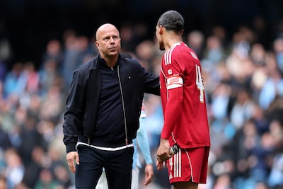 manchester-england-april-04-arne-slot-manager-of-liverpool-and-virgil-van-dijk-of-liverpool-react-at.jpeg