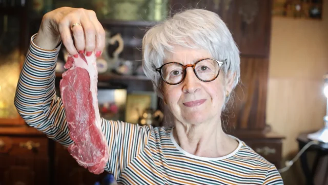 senior-woman-holding-raw-beef-steak.webp.webp