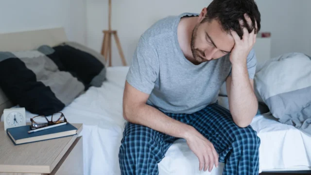 tired-man-waking-up-early-with-headache.webp.webp
