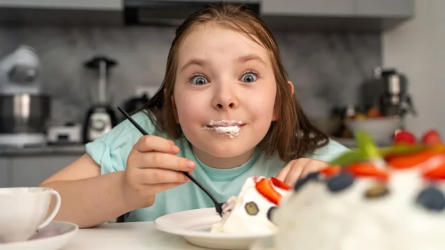 cheerful-girl-eating-cake.webp.webp