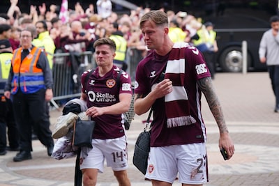 emotional-heart-of-midlothian-players-cameron-devlin-left-and-frankie-kent-walk-past-fans-as-they-ar.jpeg