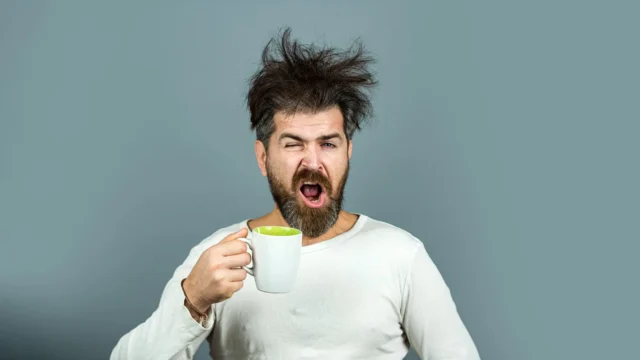 tired-man-with-messy-hair-drinking-morning-coffee.webp.webp