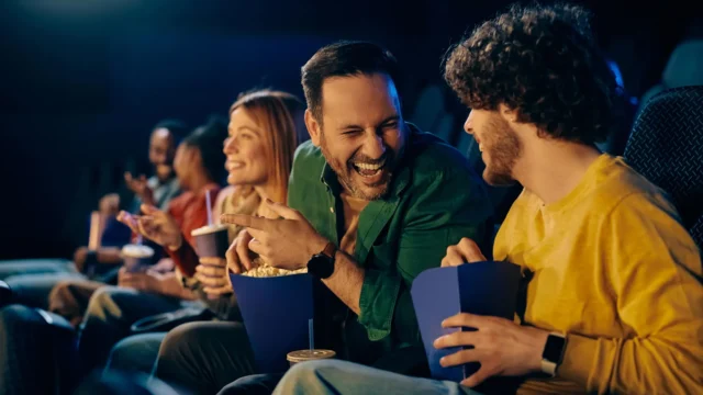 cheerful-man-laughing-watching-movie-in-theater.webp.webp