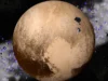 A perda do status planetário de Plutão pode ser a melhor coisa que já aconteceu à diversidade do sistema solar A planet with red patches and cream patches against a dark background.